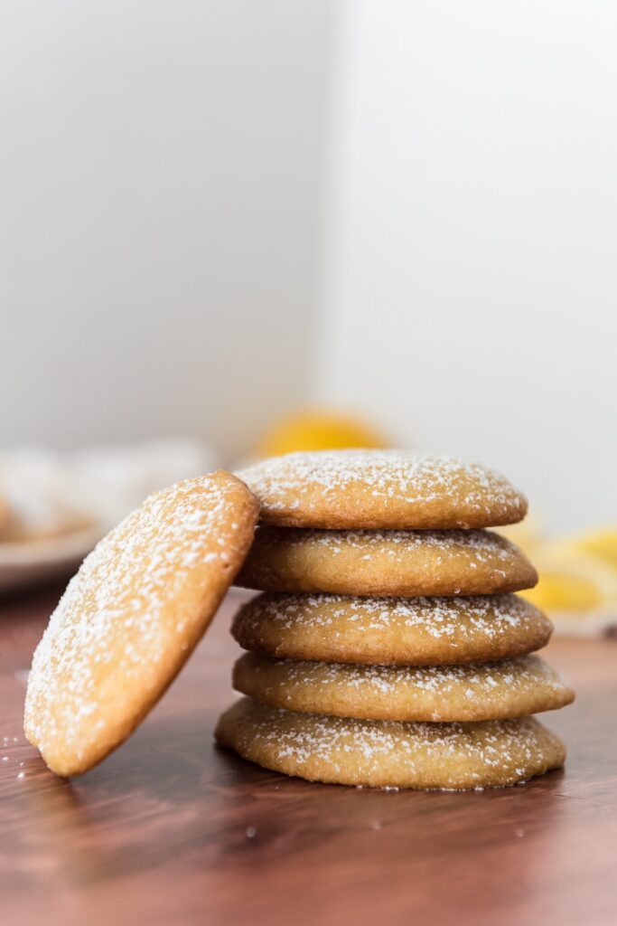 5 lemon cookies stacked together with fifth cookie leaned against stack