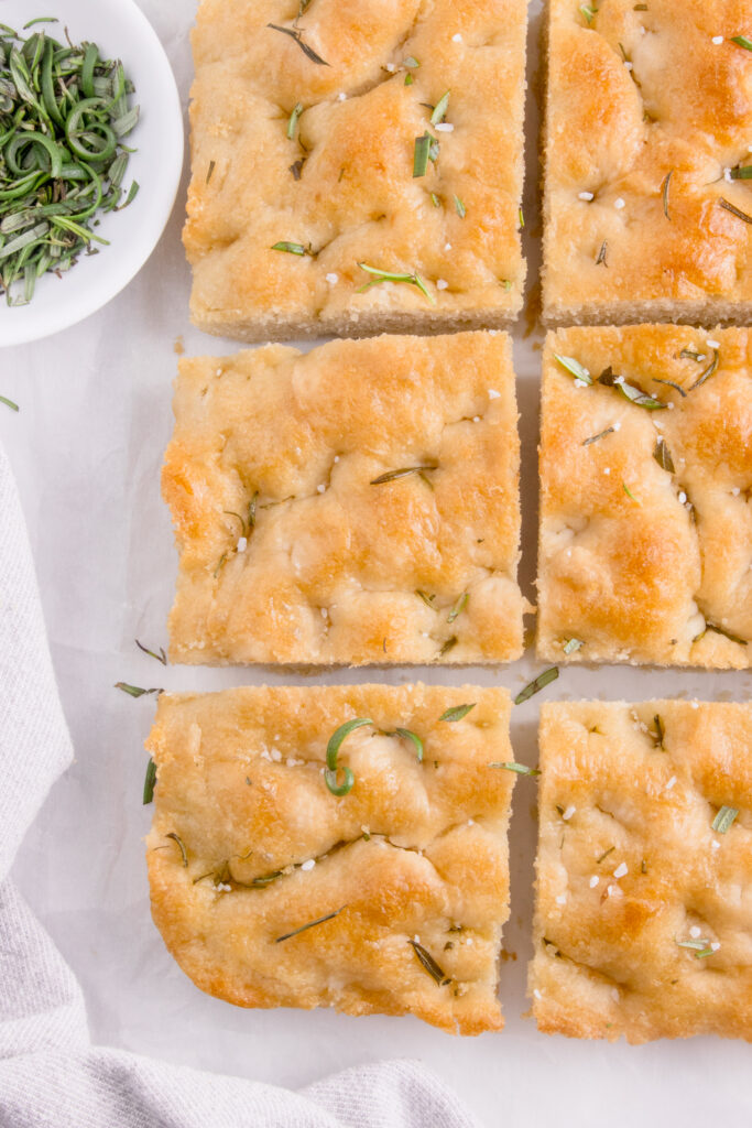 squares of focaccia with rosemary sprinkled on top