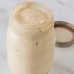 glass mason jar filled with active sourdough starter