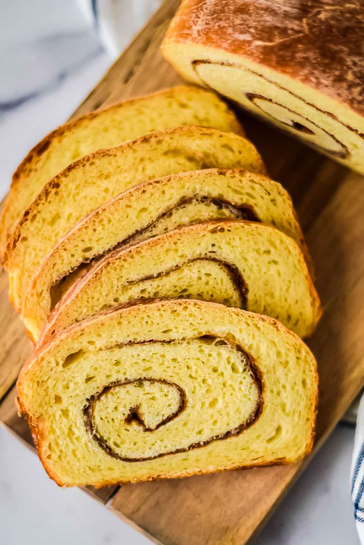 overhead view of cinnamon swirl sourodugh loaf cut into slices and arranged on top of each other