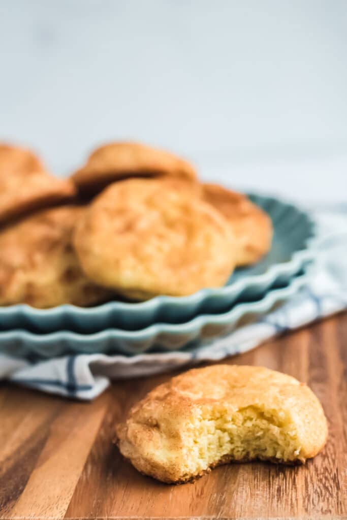 blue plates stacked wtih cookies with one cookie in front having a bite taken out to show texture