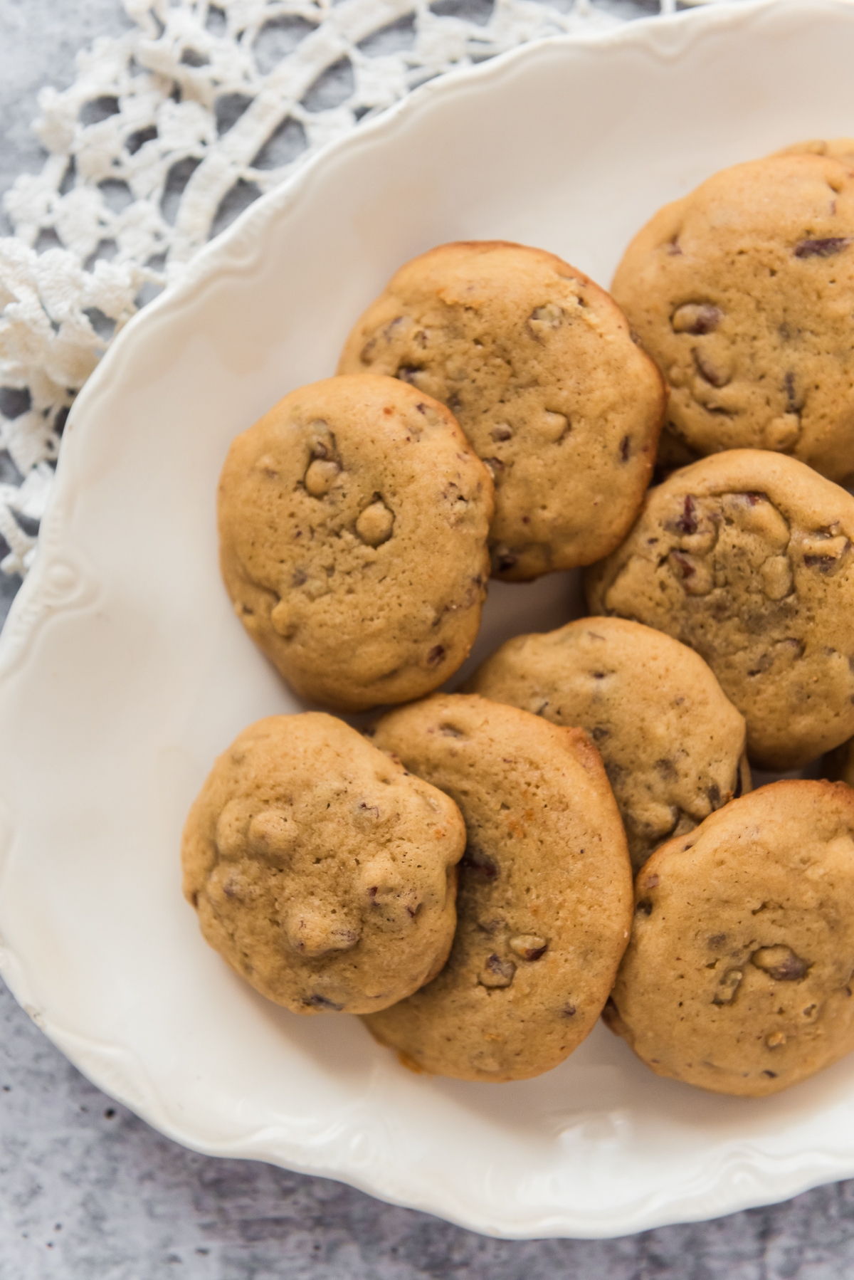overhead image of white platter with sourdough butter pecan cookies