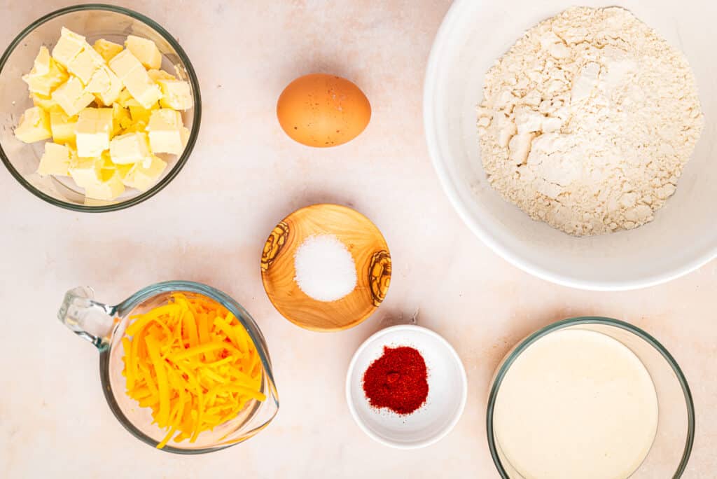 ingredients for sourdough cheese straws on counter in glass bowls