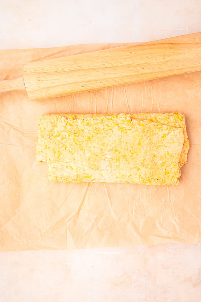 dough folded in thirds on parchment paper