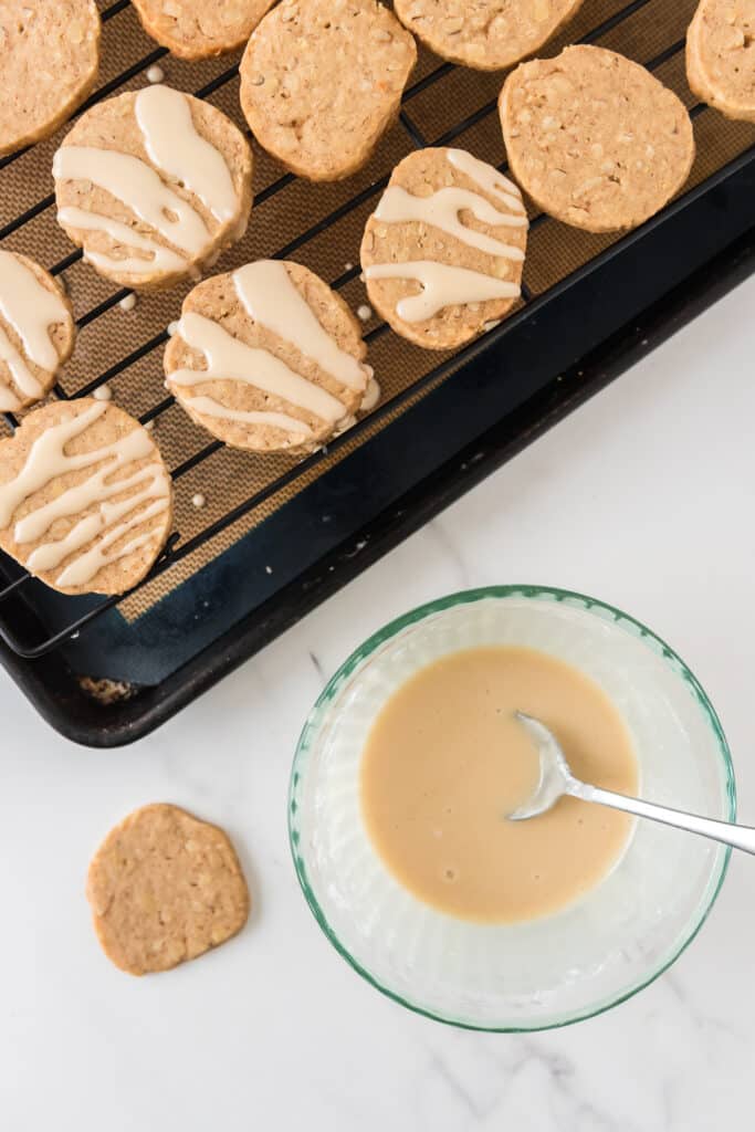 drizzling icing on cookies on wire rack