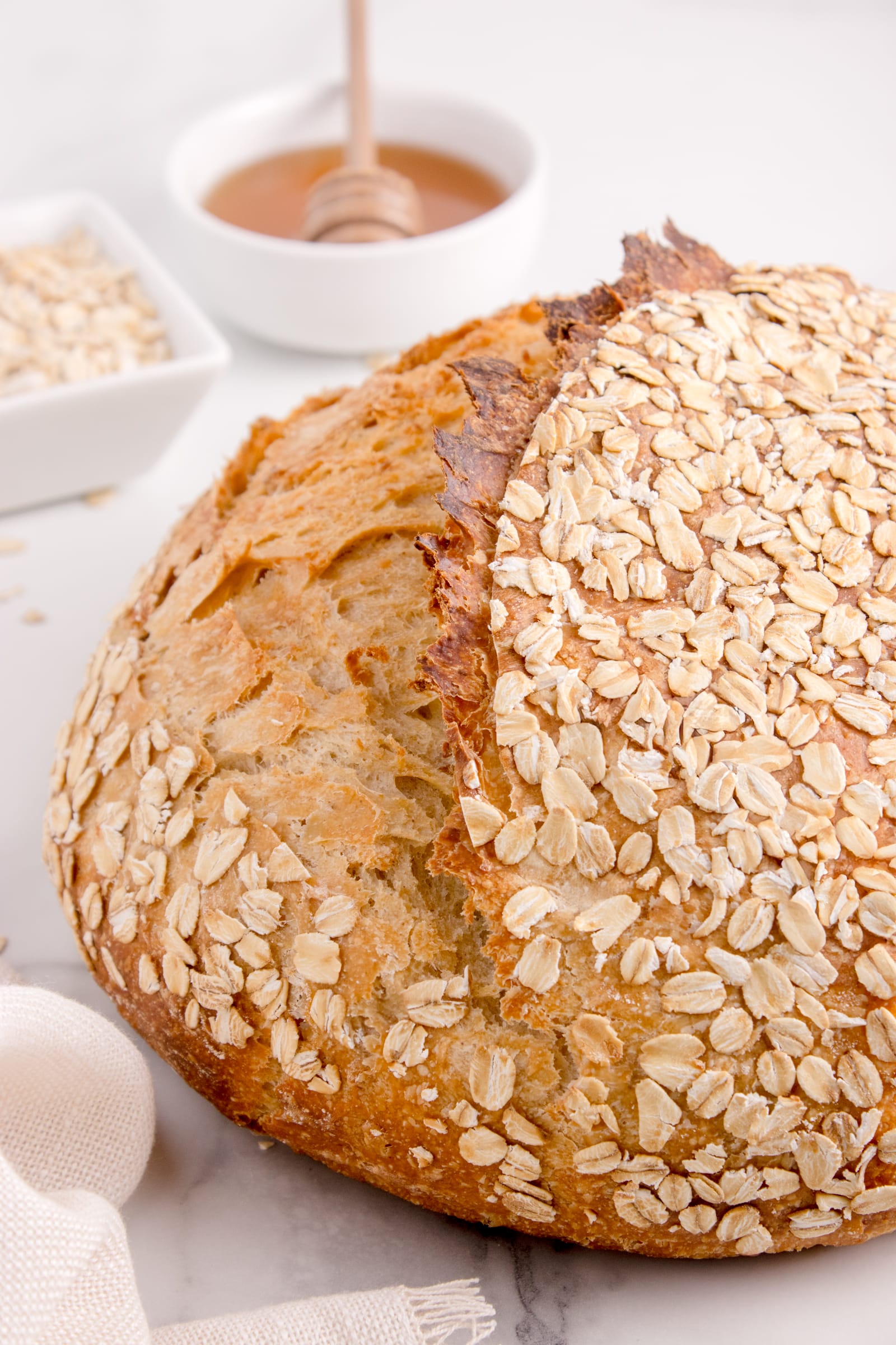 loaf of sourdough bread with honey and oats
