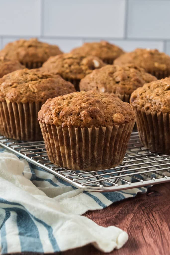 corner view of wire cooling rack with applesauce muffins lined up