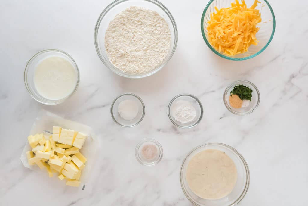 overhead view of ingredients for sourdough drop biscuits on marble counter