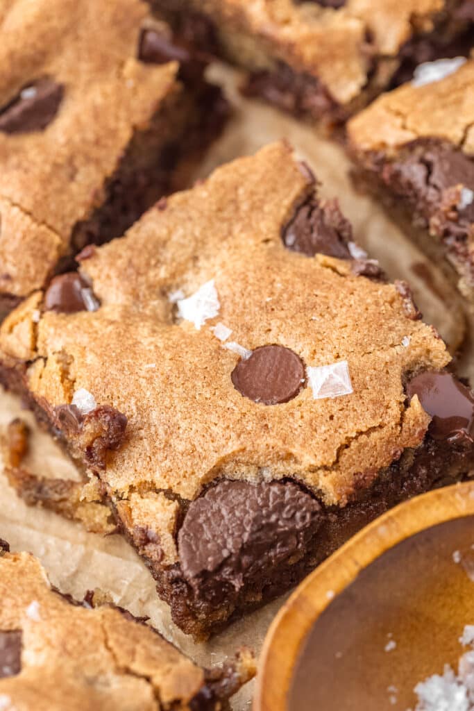 closeup of sourdough chocolate chip cookie bar with flakey salt on top