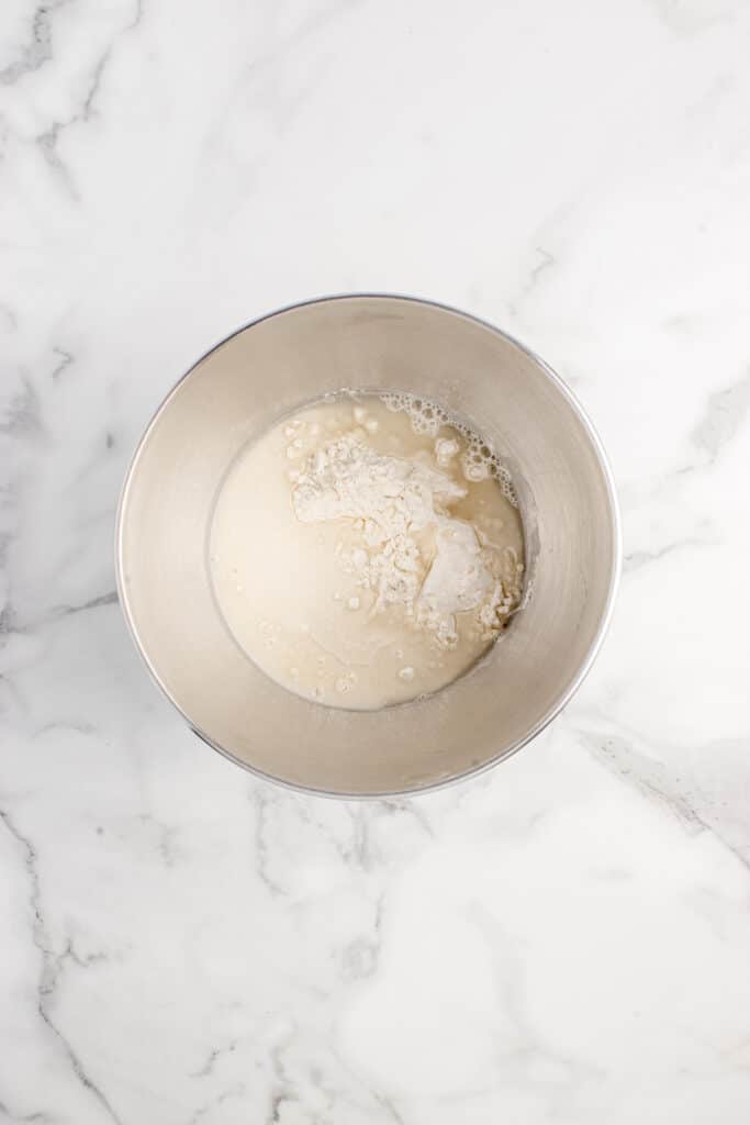 metal mixing bowl with ingredients for dumpling wrappers ready to be mixed