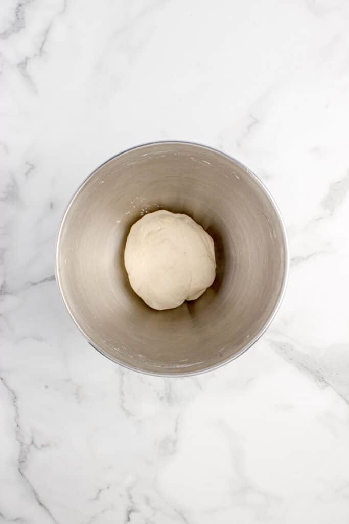 metal mixing bowl with dough for dumpling wrappers