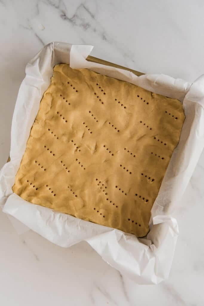 shortbread crust pressed into pan with fork pricks