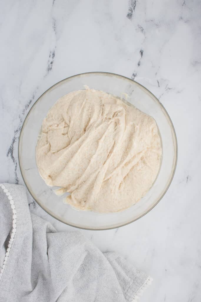 glass bowl with sourdough ciabatta dough after two rounds of stretch and folds
