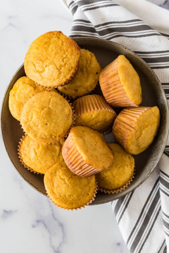 grey bowl filled with sourdough discard corn muffins