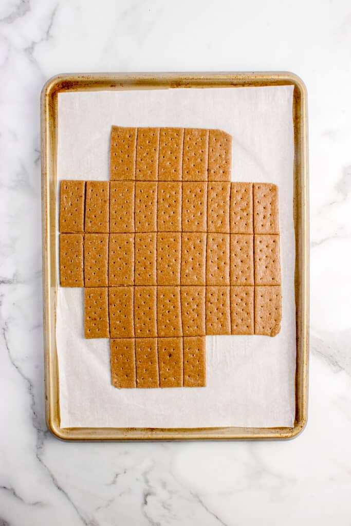 baking sheet with sourdough graham crackers on parchment paper