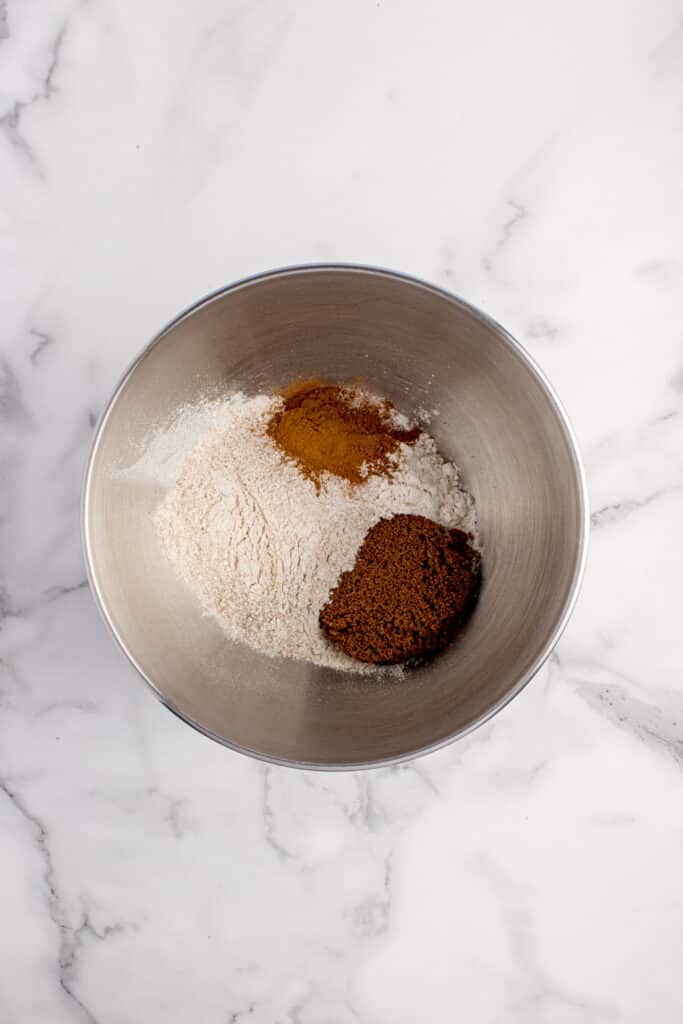 metal mixing bowl with flour and spices
