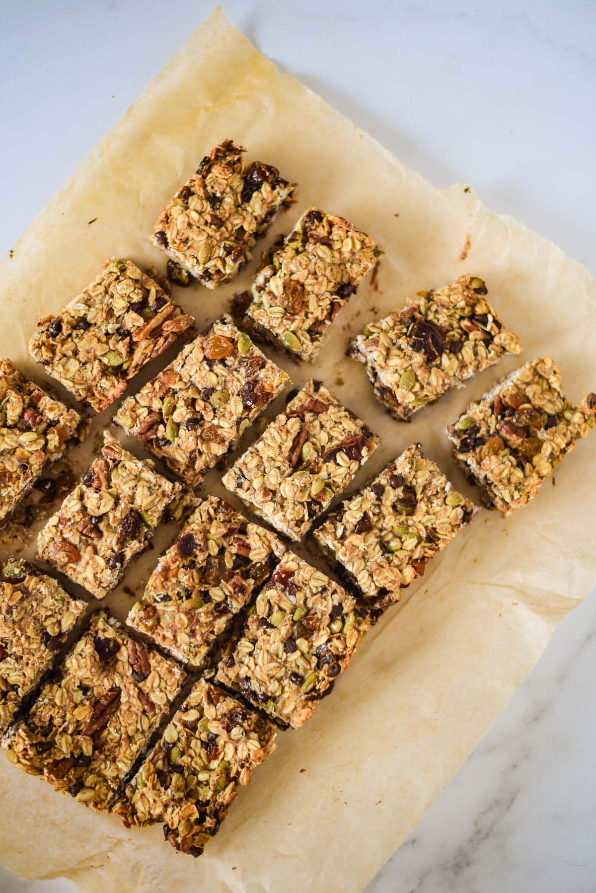 sourdough granola bars cut apart and arranged on parchment paper