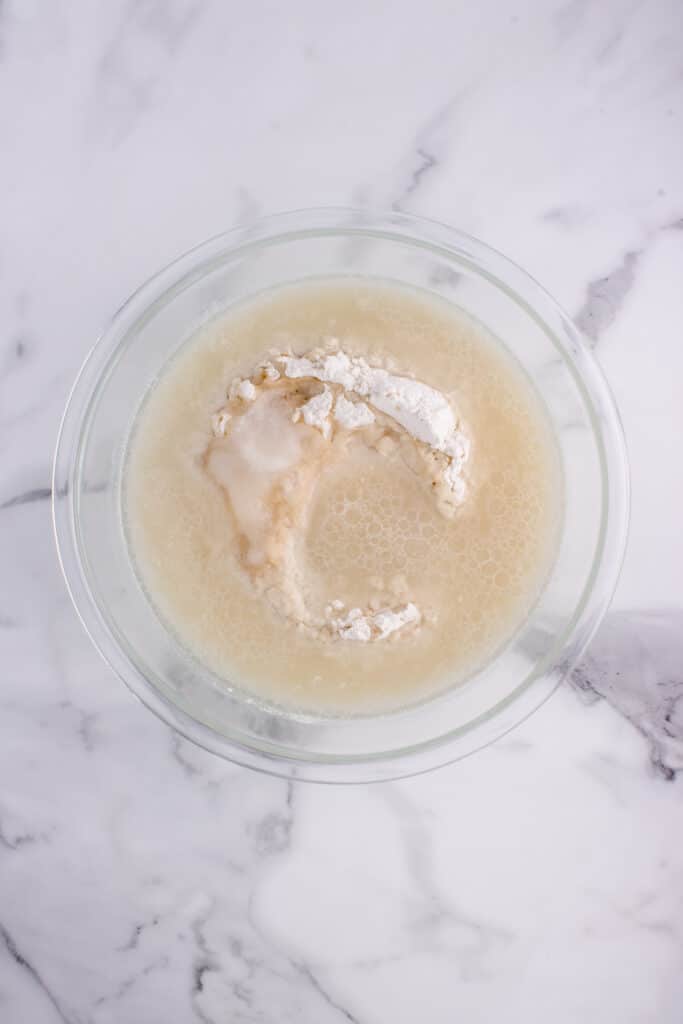large glass bowl with ingredients for potato flake bread