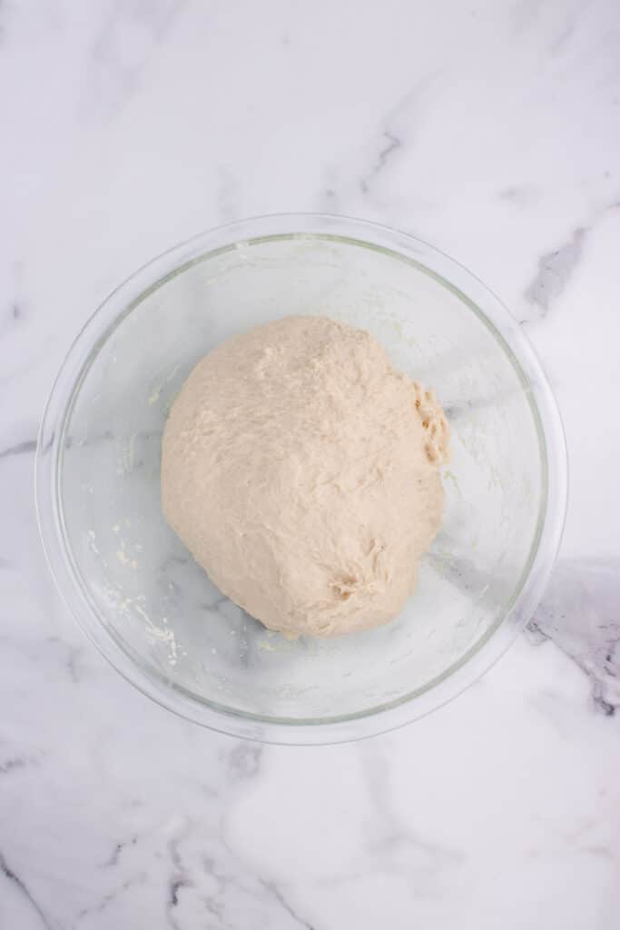 large glass bowl with dough mixed