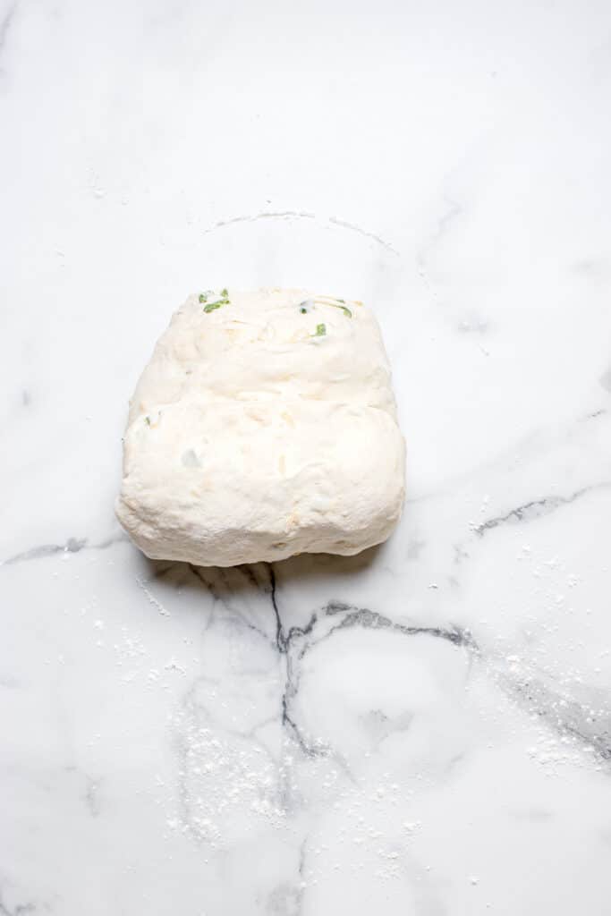 rolling sourdough bread dough into log for shaping