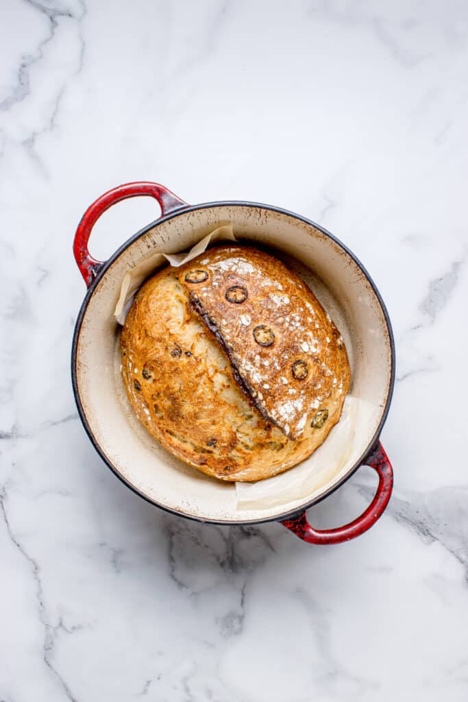 freshly baked sourdough jalapeño bread in dutch oven