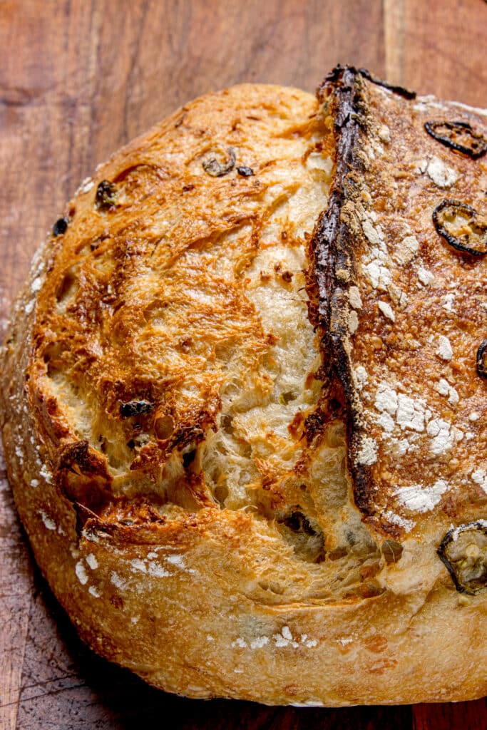 closeup of jalapeño cheddar sourdough. bread showing ear and crust