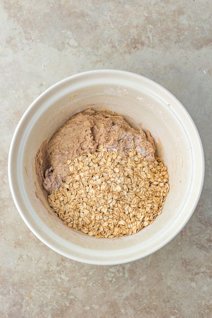 mixing bowl with wet ingredients and oats ready to be mixed for cookies