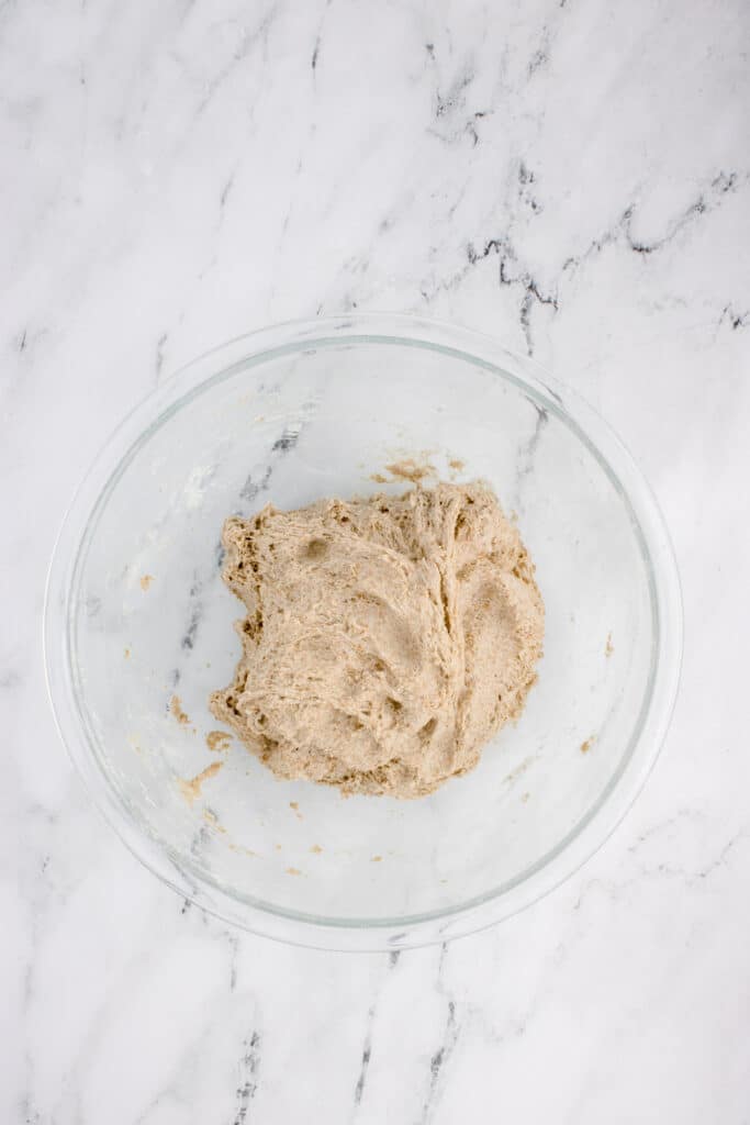 glass mixing bowl with dough for sourdough rye after stretch and fold