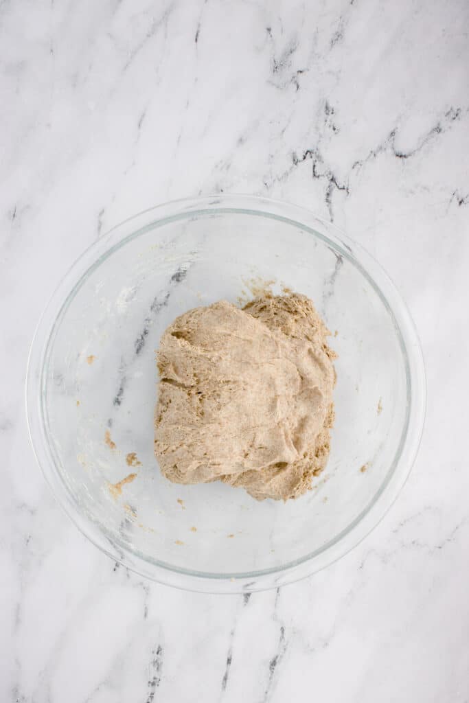 glass mixing bowl with dough for sourdough rye after stretch and fold
