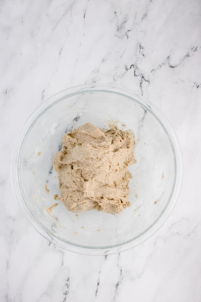glass mixing bowl with dough for sourdough rye after stretch and fold