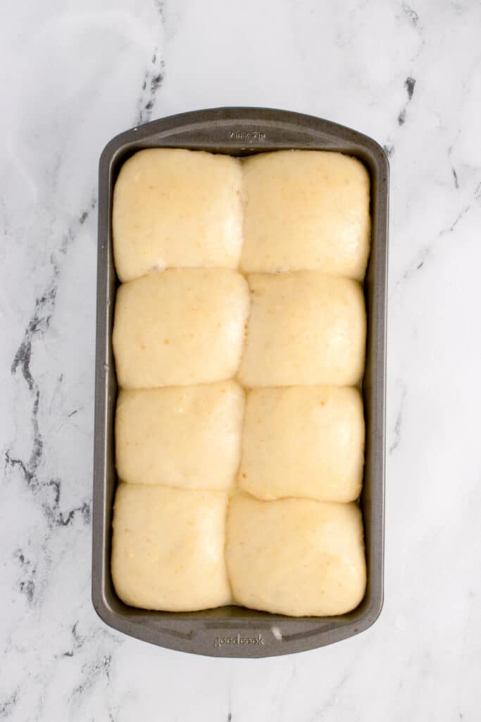 sourdough brioche dough in metal loaf pan ready to be baked