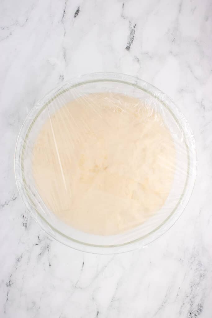 glass bowl with dough for brioche before fermentation