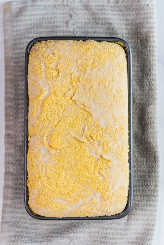 metal loaf pan with sourdough English muffin dough that has doubled and is ready to bake