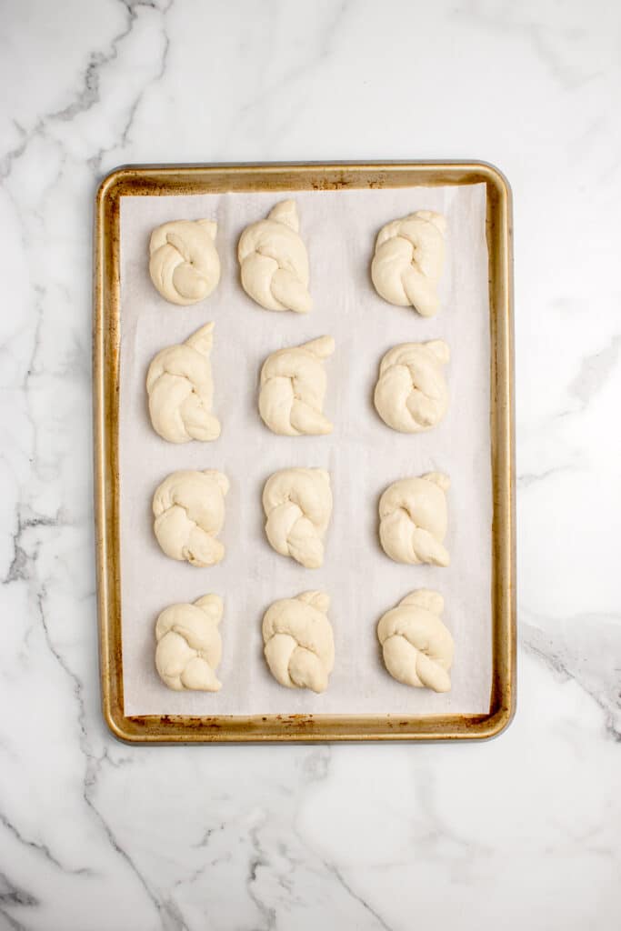sourdough garlic knots on baking tray after shaping
