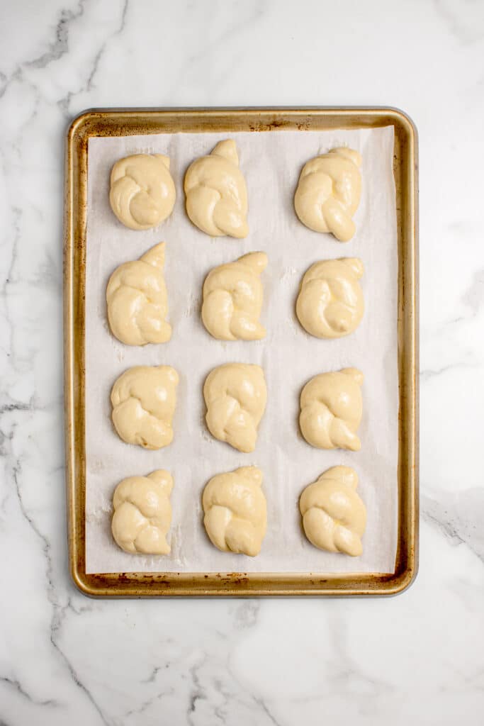 sourdough garlic knots on baking tray after final proofing
