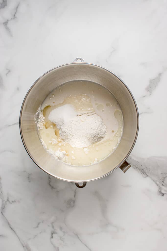 metal mixing bowl with ingredients added for sourdough garlic knots