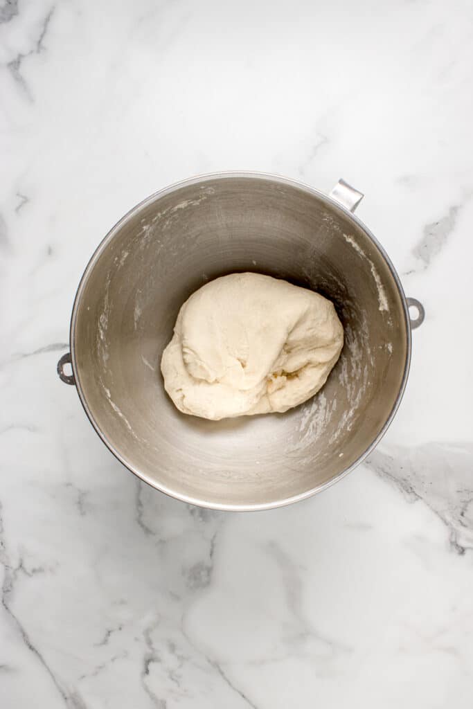metal mixing bowl with dough for garlic knots after stretch and fold