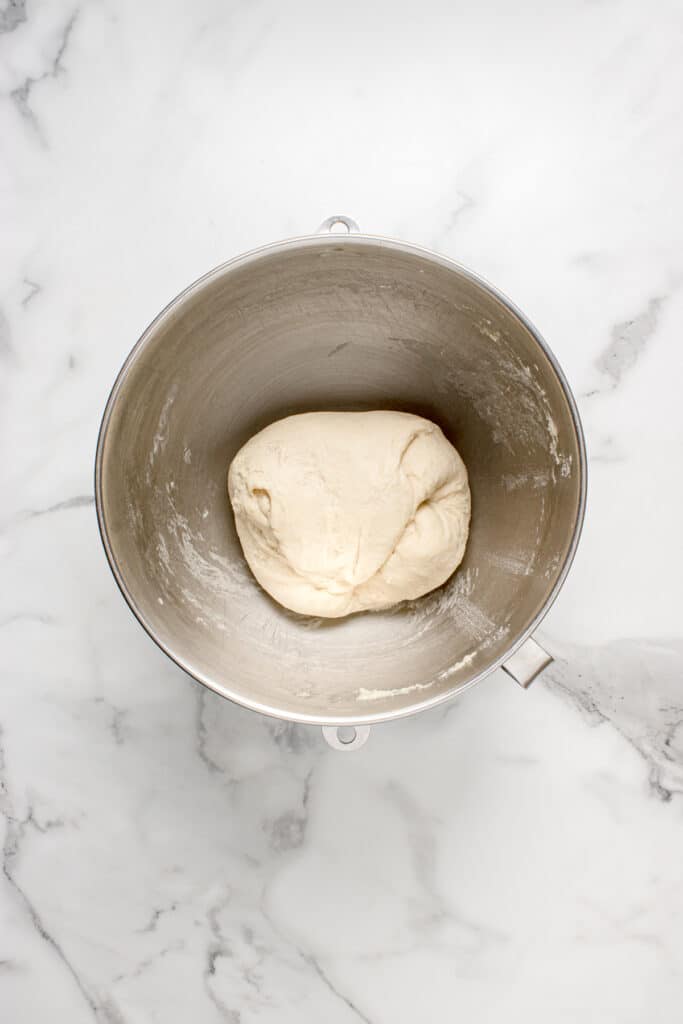 metal mixing bowl with dough for garlic knots after stretch and fold