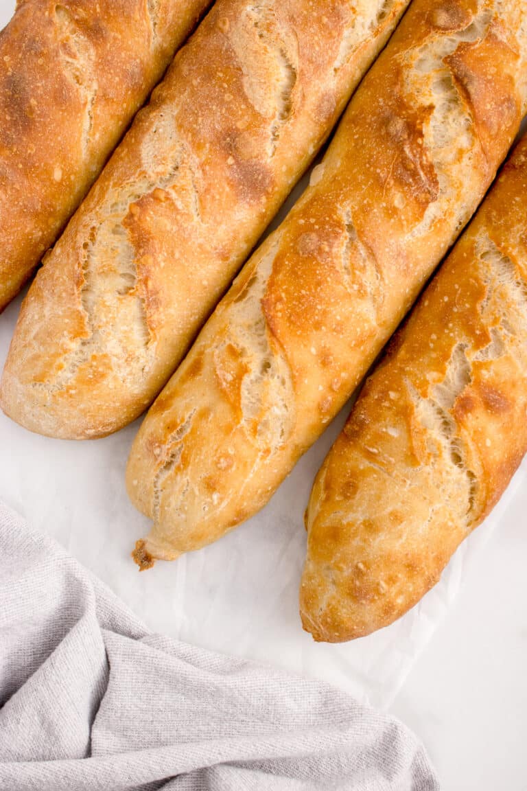 four loaves of sourdough baguette on white counter