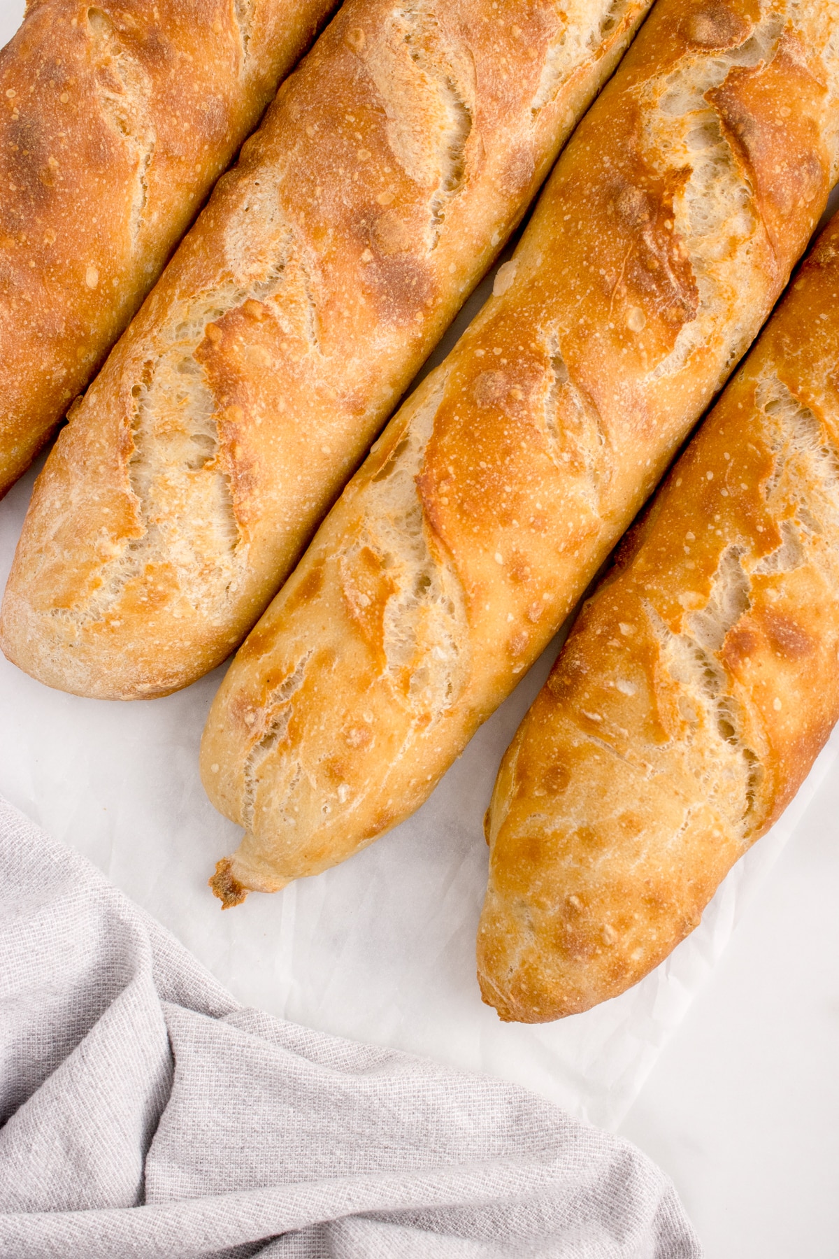 four loaves of sourdough baguette on white counter