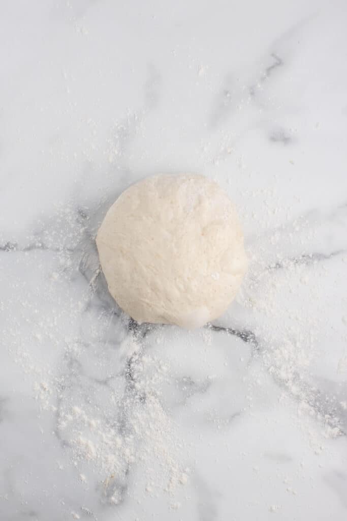 ball of dough on marble counter