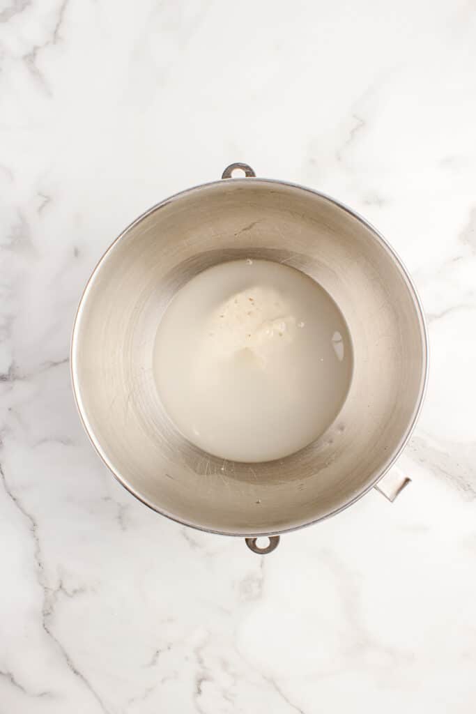 metal mixing bowl with water and sourdough starter