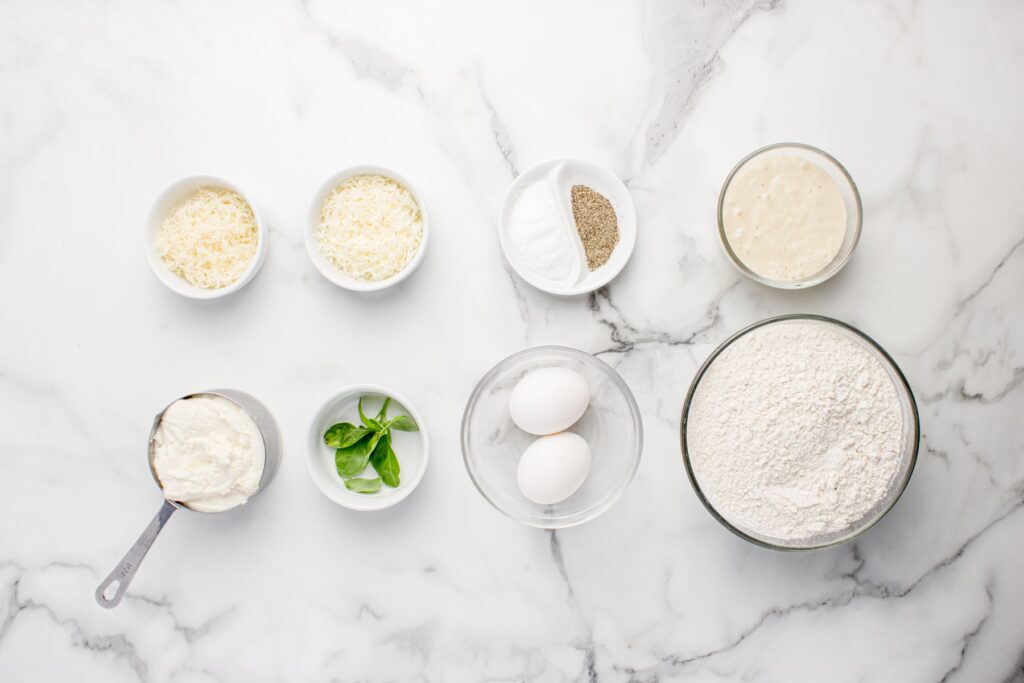 ingredients for sourdough ravioli in glass bowls on marble counter