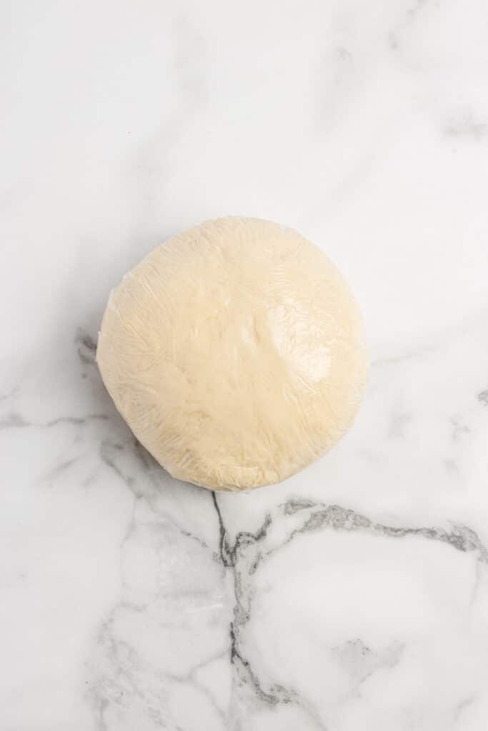 sourdough ravioli dough ball wrapped in plastic