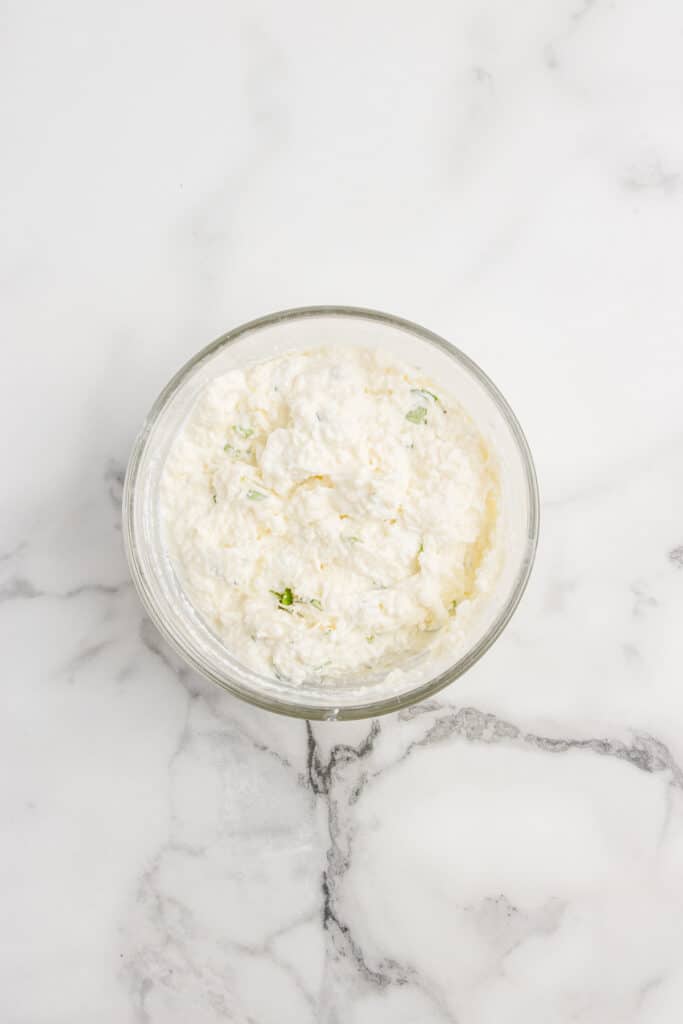 glass mixing bowl with mixed cheese filling for ravioli