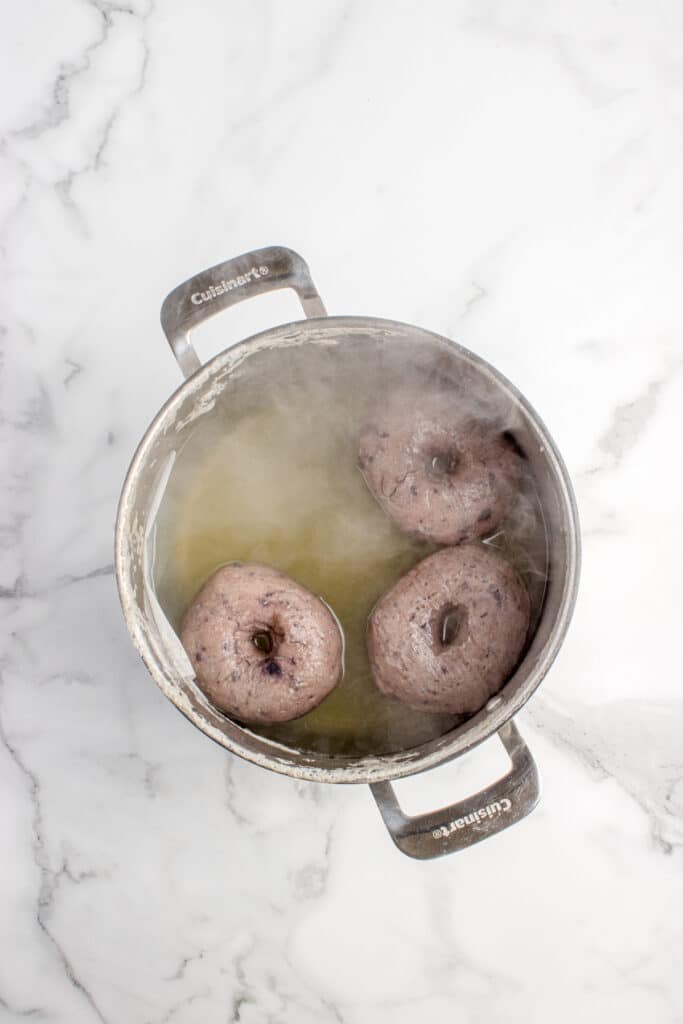 large pot with boiling water and bagels