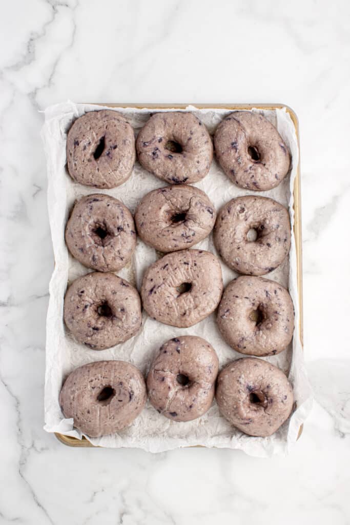 pan with boiled blueberry bagels