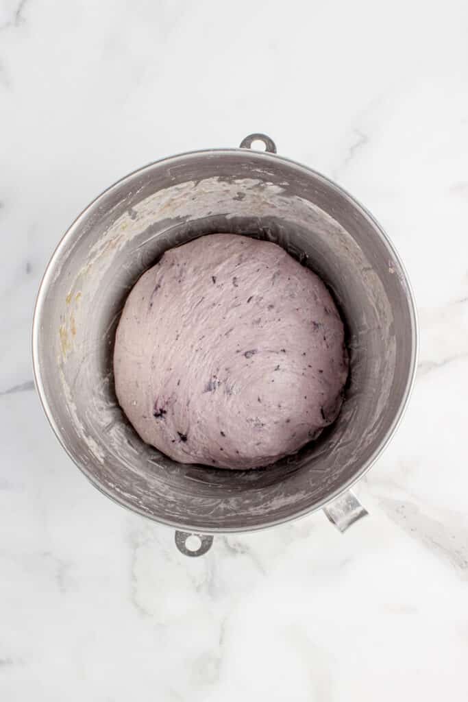 metal mixing bowl with dough for sourdough blueberry bagels