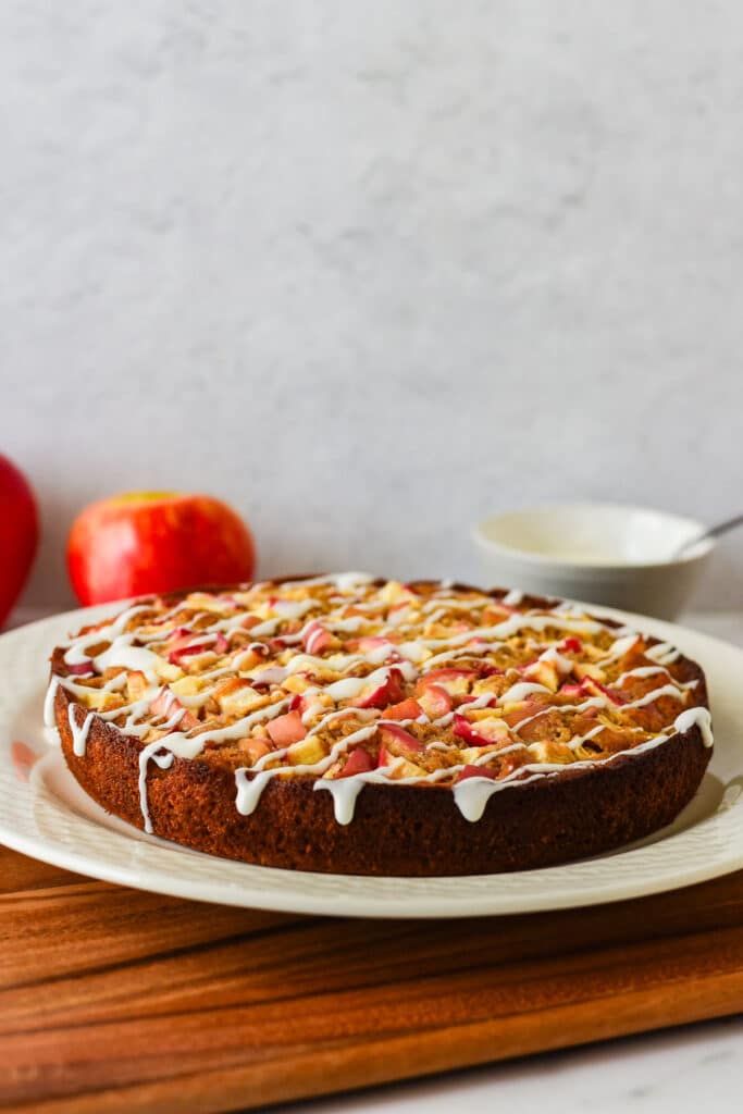 sourdough apple cake with icing drizzle on white platter