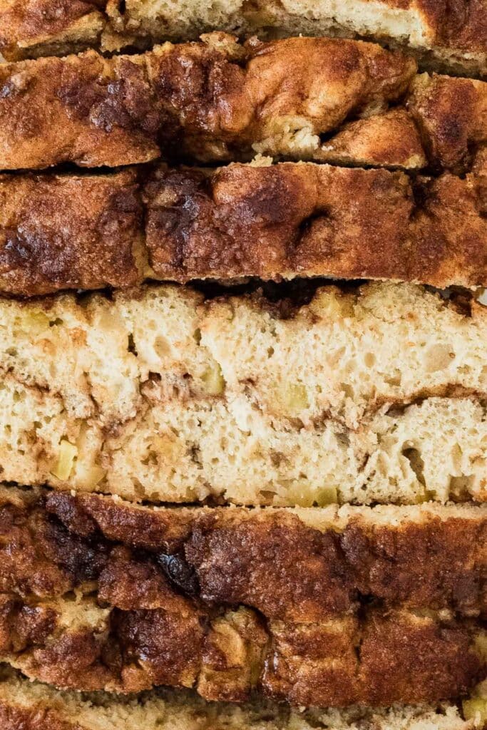 close up of slices of sourdough apple cinnamon focaccia stacked together, with center piece turned to show inside crumb